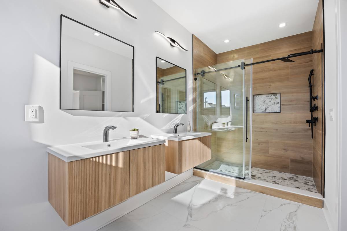Bathroom with teal onyx tile, gold faucet and matte black shower fixtures