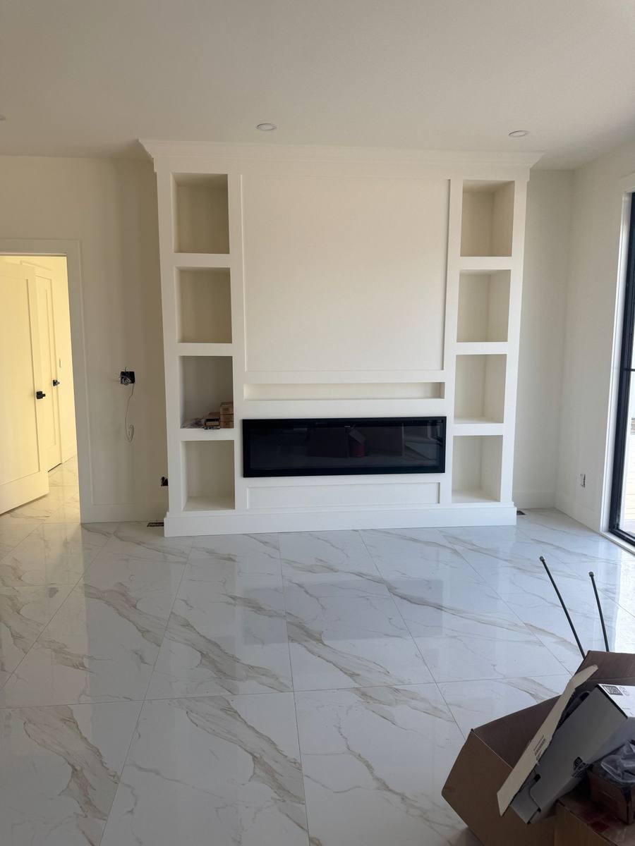 Custom built-in fireplace wall with shelving niches