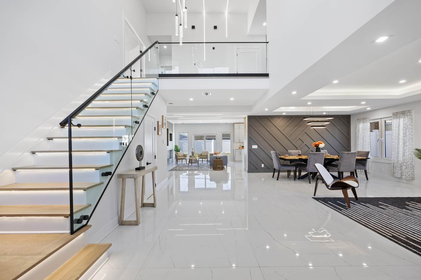 Luxury two-story foyer with LED floating staircase and glass railing built by Cabra Prestige Group