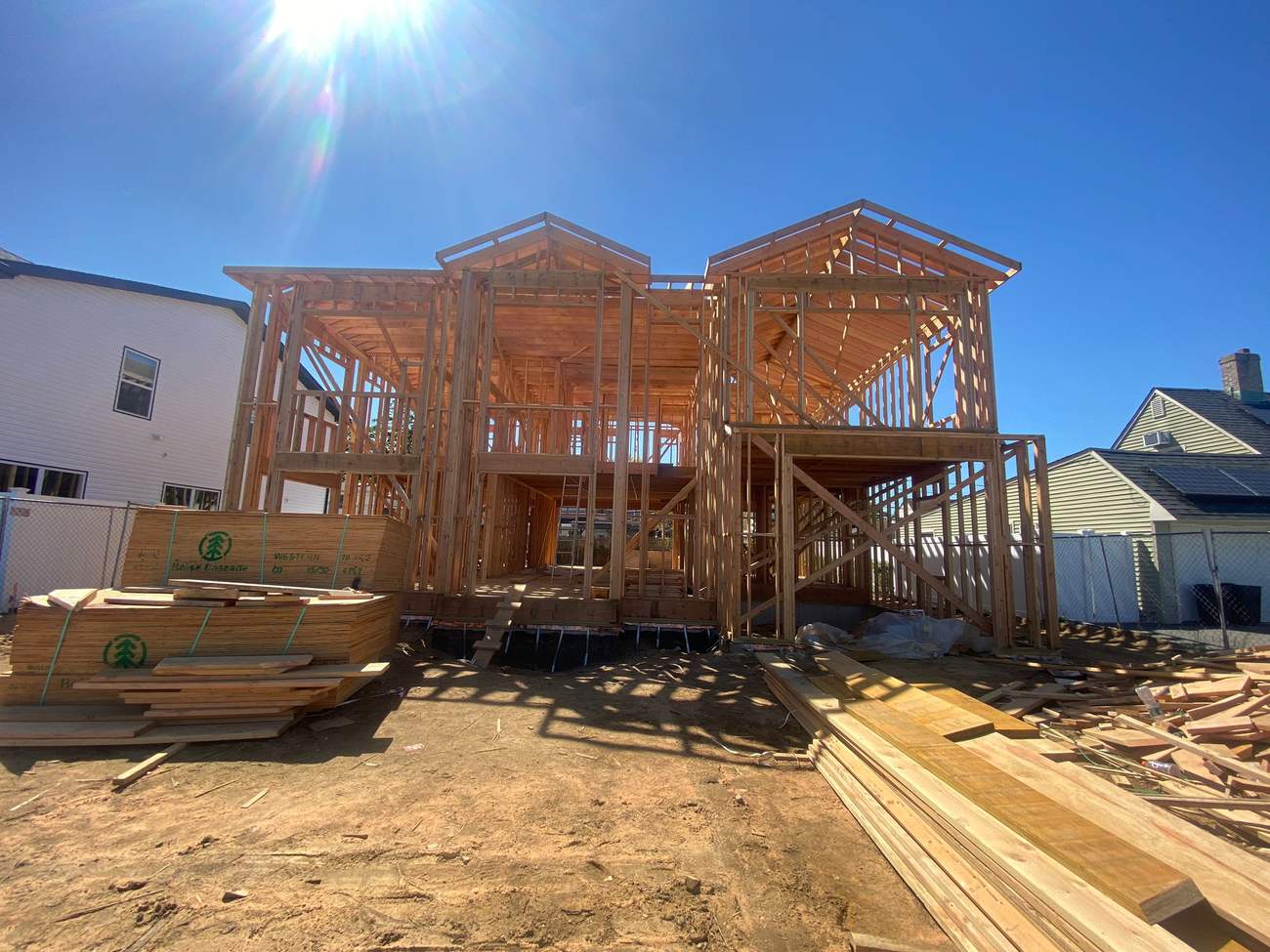 Full wood framing of a new home under blue sky