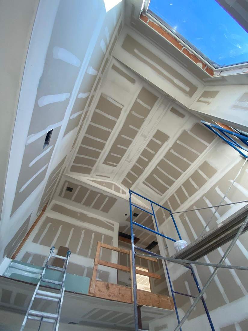 Sheetrock installation, taping and spackle on a vaulted ceiling with skylight by Cabra Prestige Group