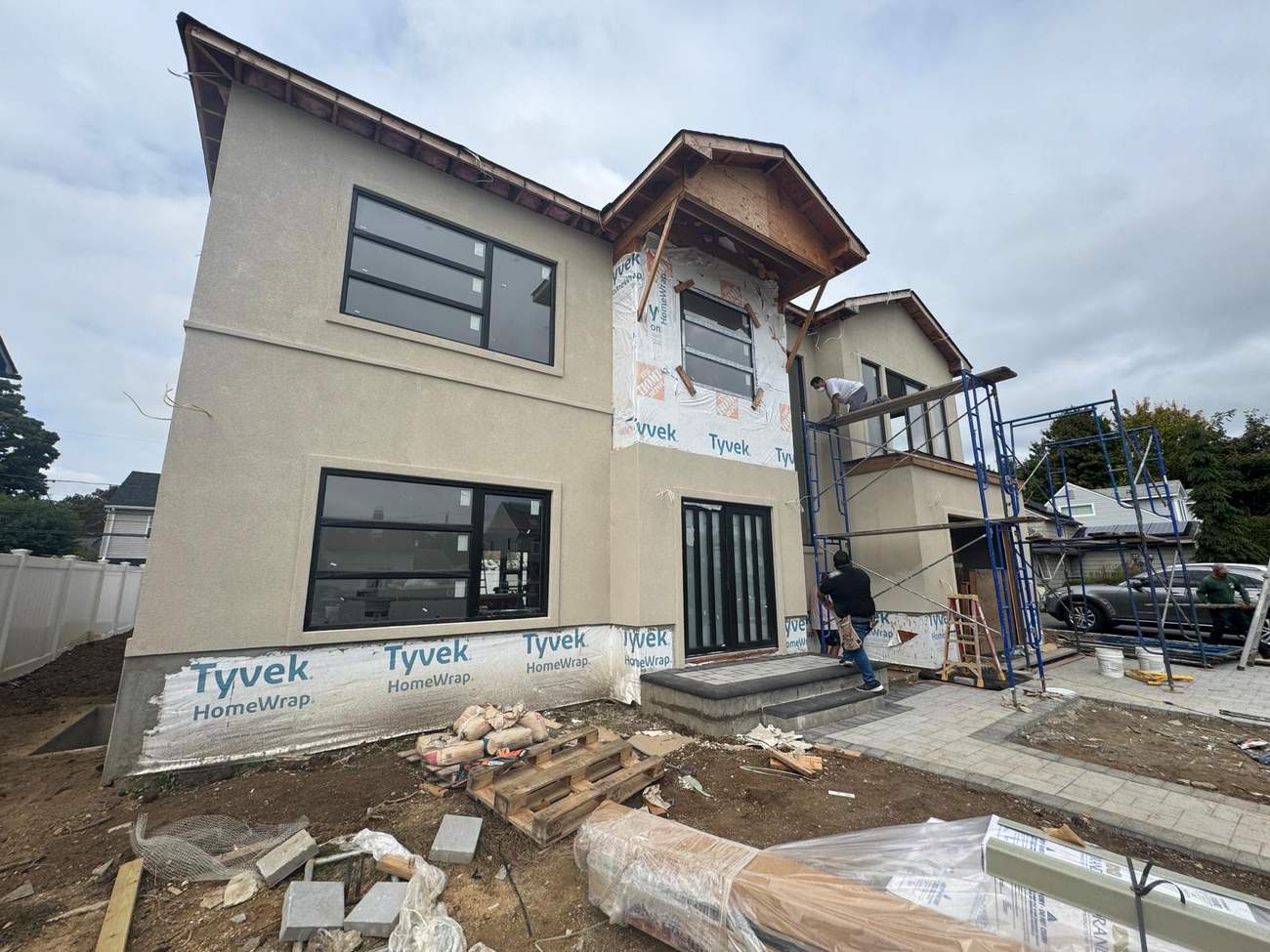 Exterior stucco and house wrap installation in progress